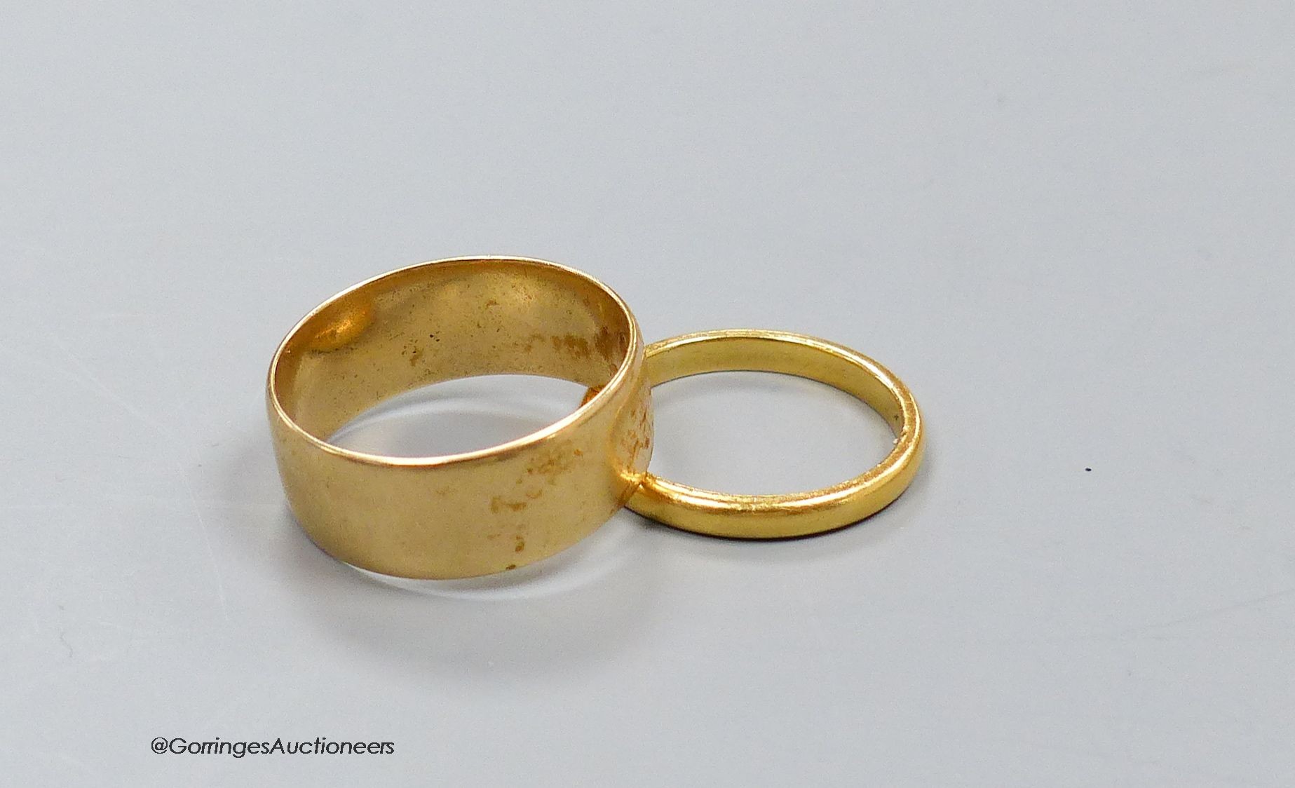 An 18ct. gold wedding band, size P, 5.9g, and a 22ct gold band, size L, 2.9g.